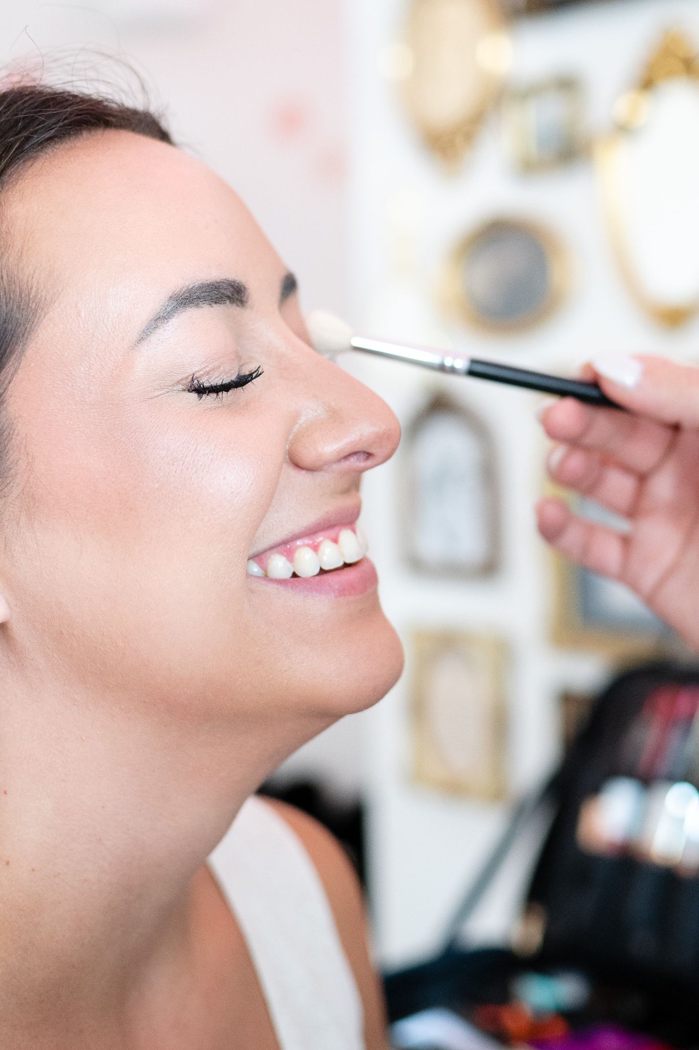 Makeup artist applies eyeshadow to a model during a brand photo shoot in Winston-Salem.