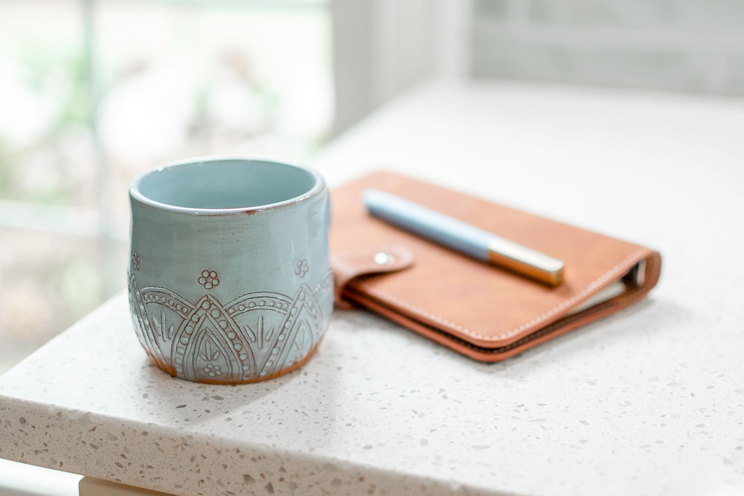 A coffee cup and notebook for this personal brand photo shoot.
