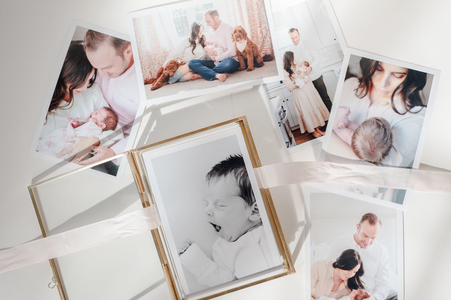 A collection of framed photographs arranged on a white surface showing lifestyle moments and portraits.