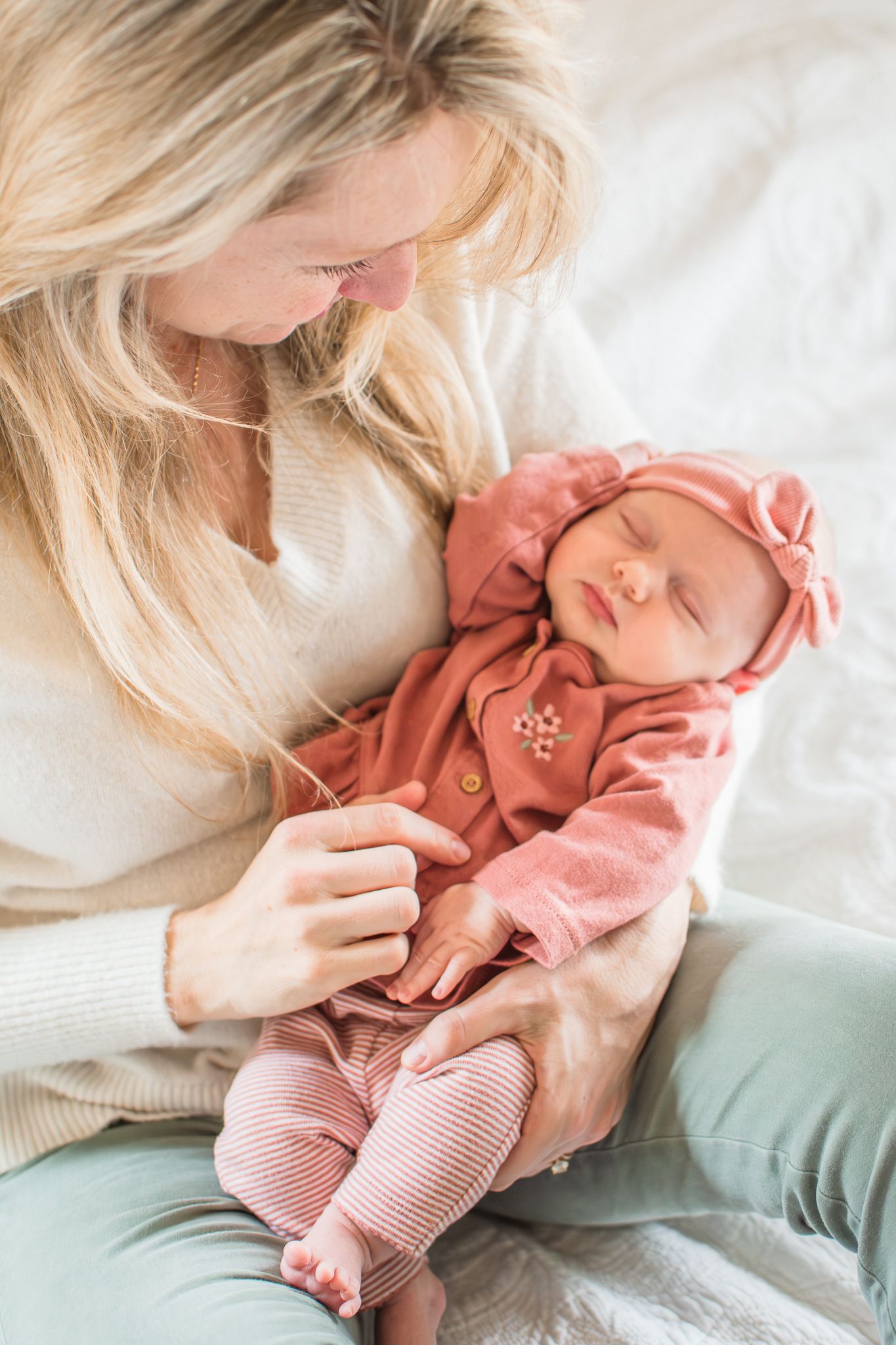 Mom holds baby close during this newborn session at their Winston-Salem home.