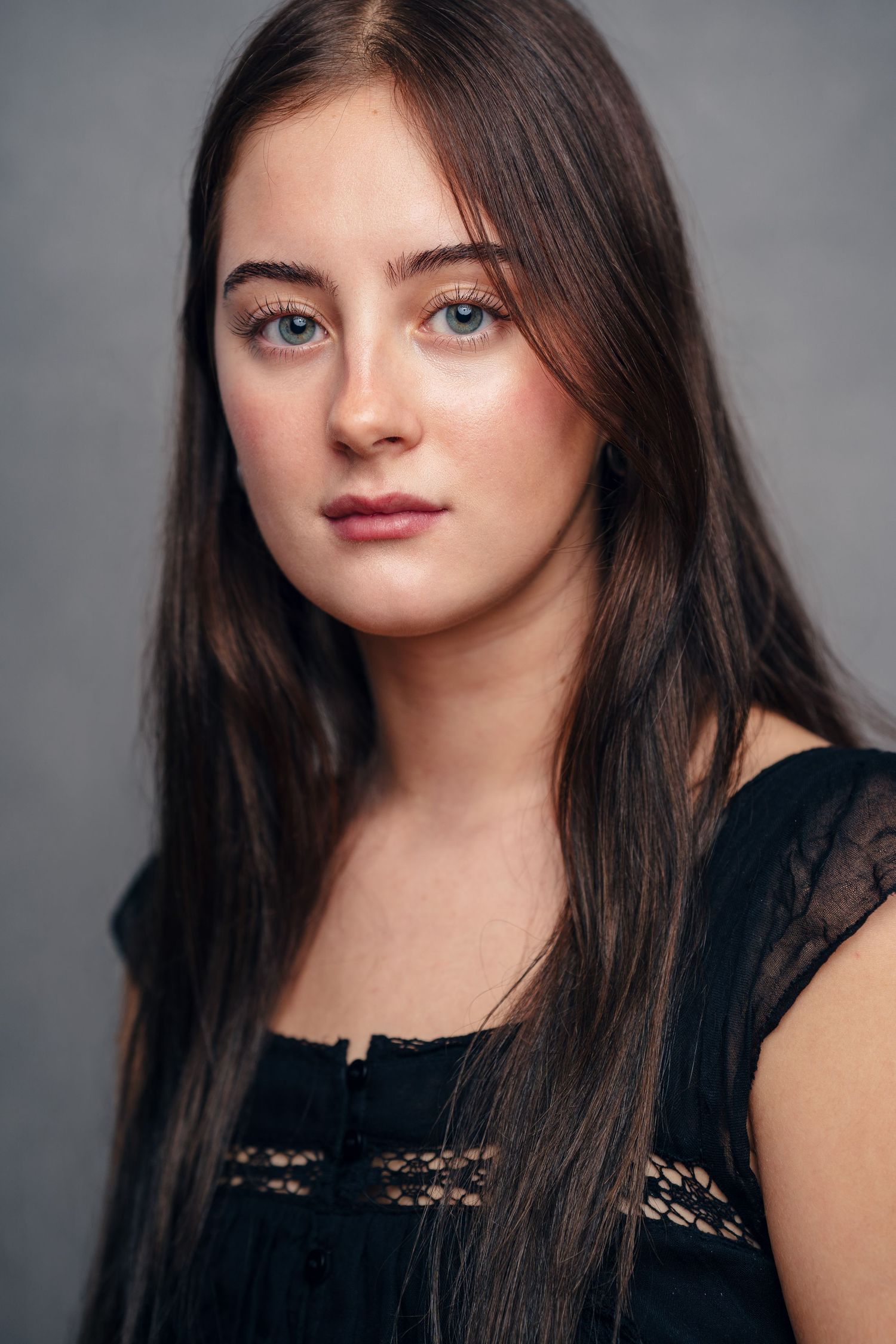 Soft moody headshot of a NYC student actor.
