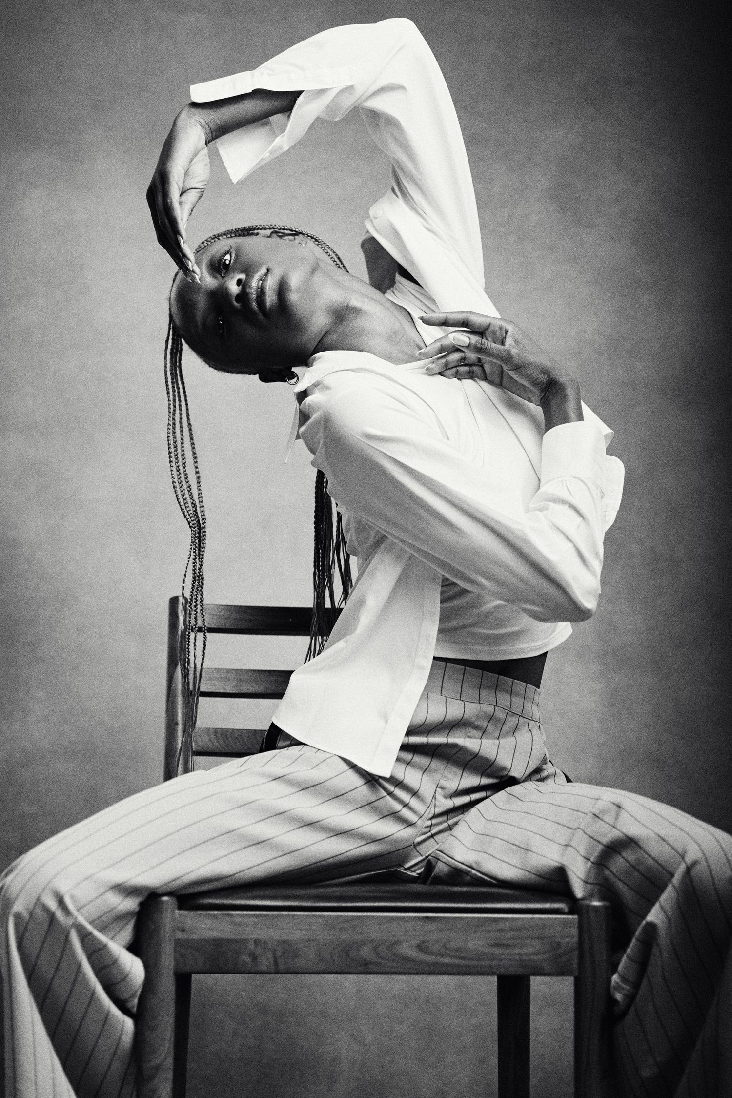 Black and white portrait of a dancer seated in a chair.