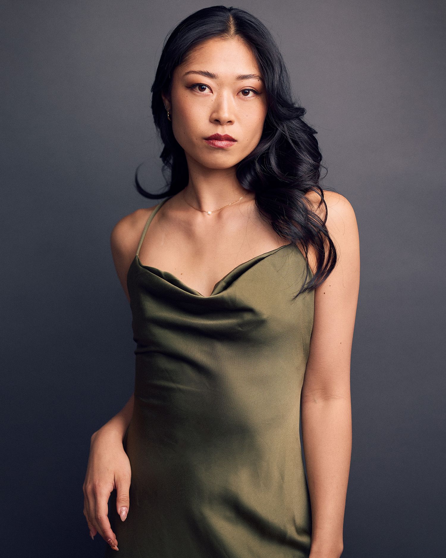 Portrait of a female dancer wearing a green satin dress.