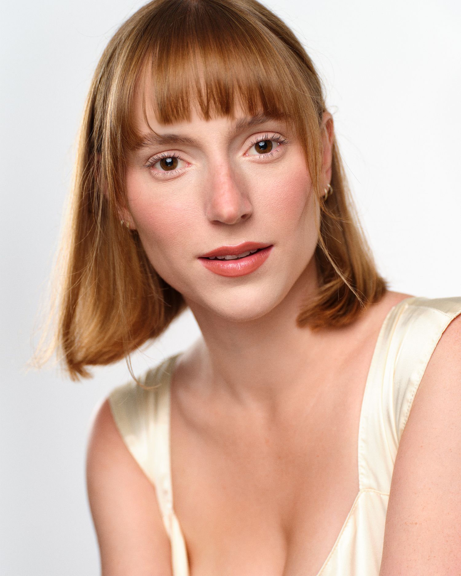 Bright, commercial headshot look with hair light.
