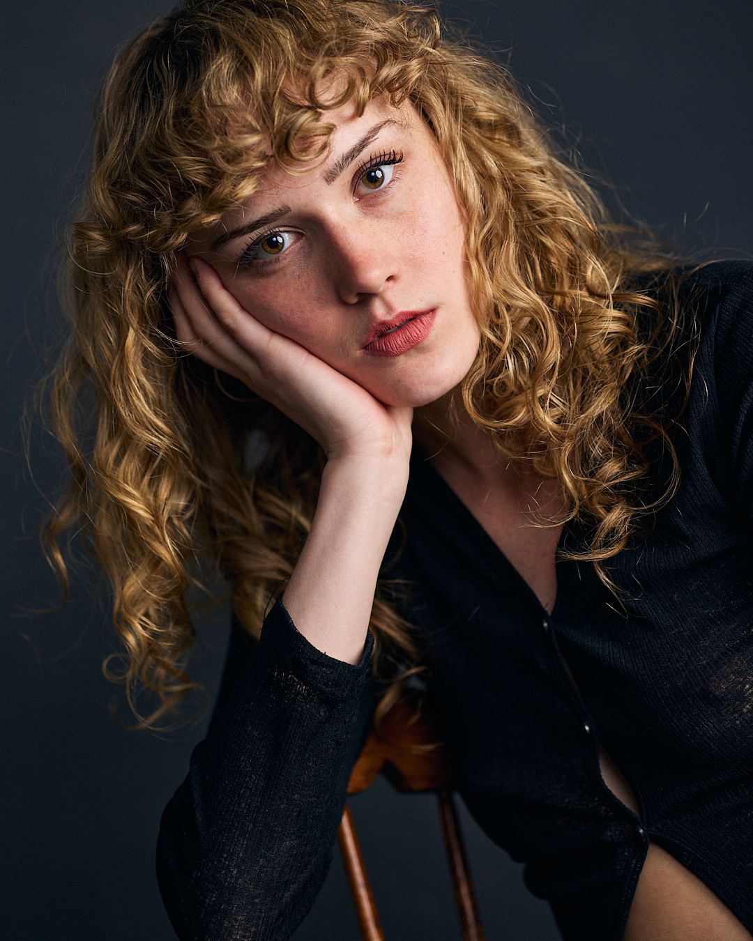 Non-traditional headshot of a female actor with styled hair.