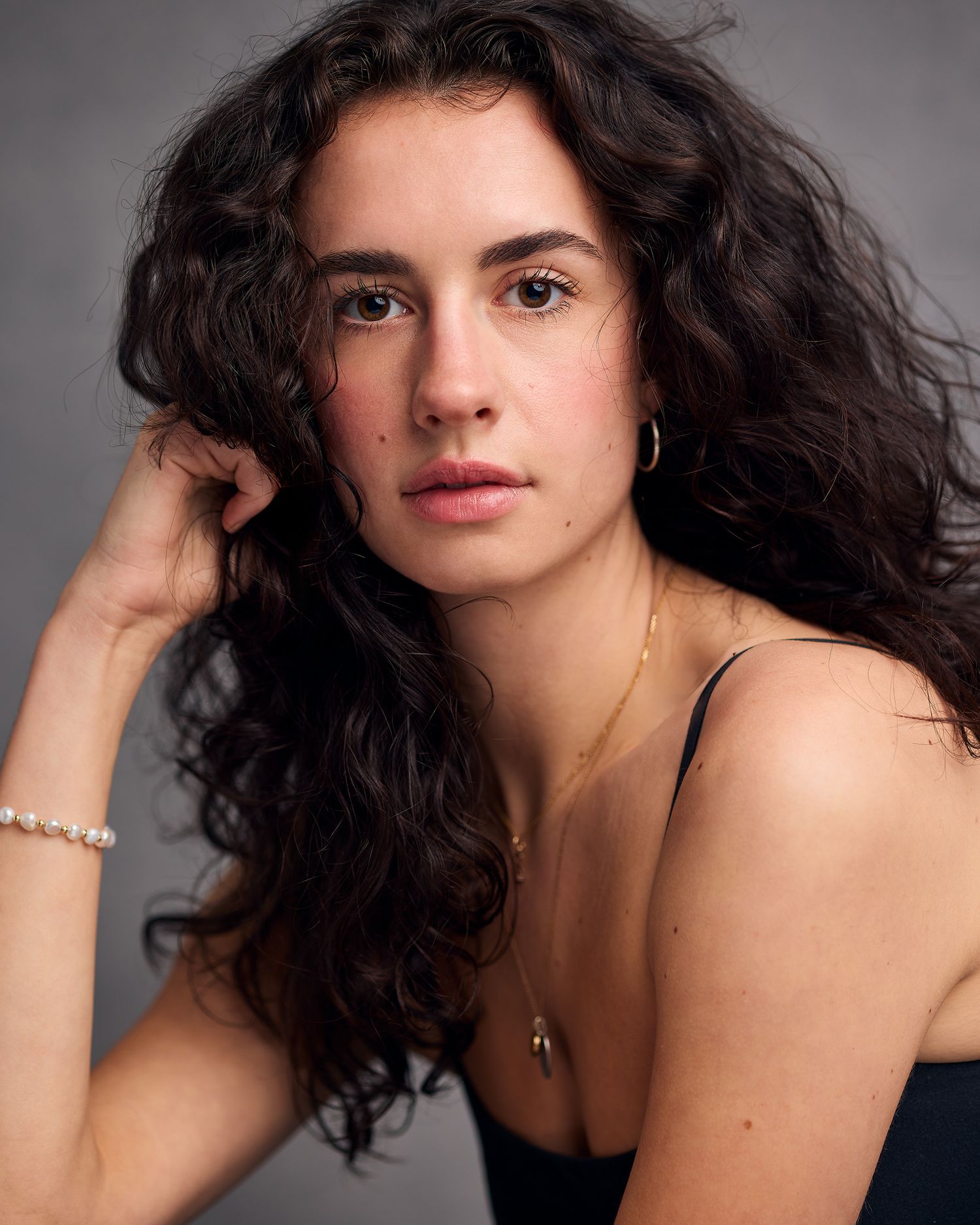 Gorgeous headshot of a female actor with hair professional styled and makeup professionally done.
