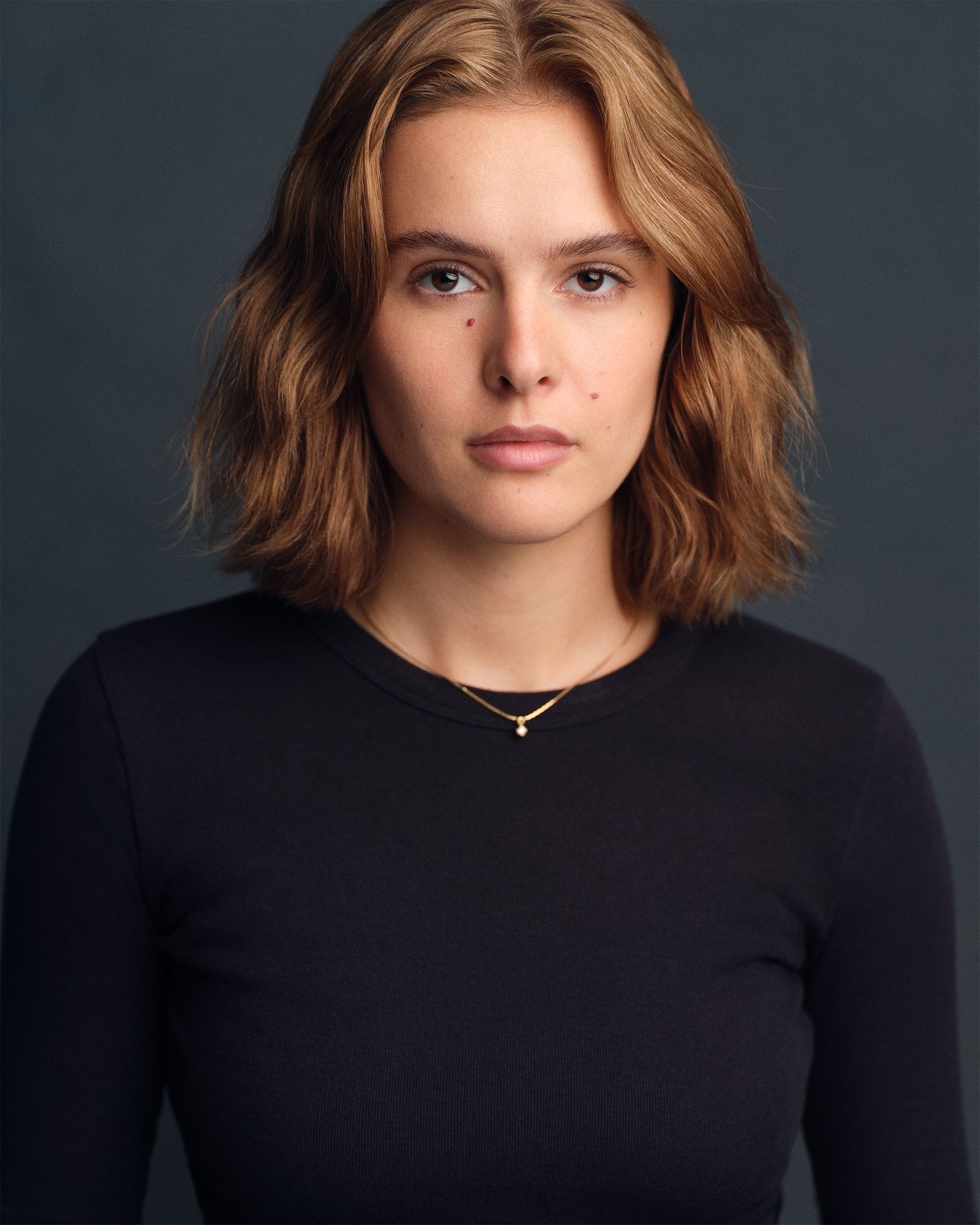 Dramatic, straight on headshot of a female actor.