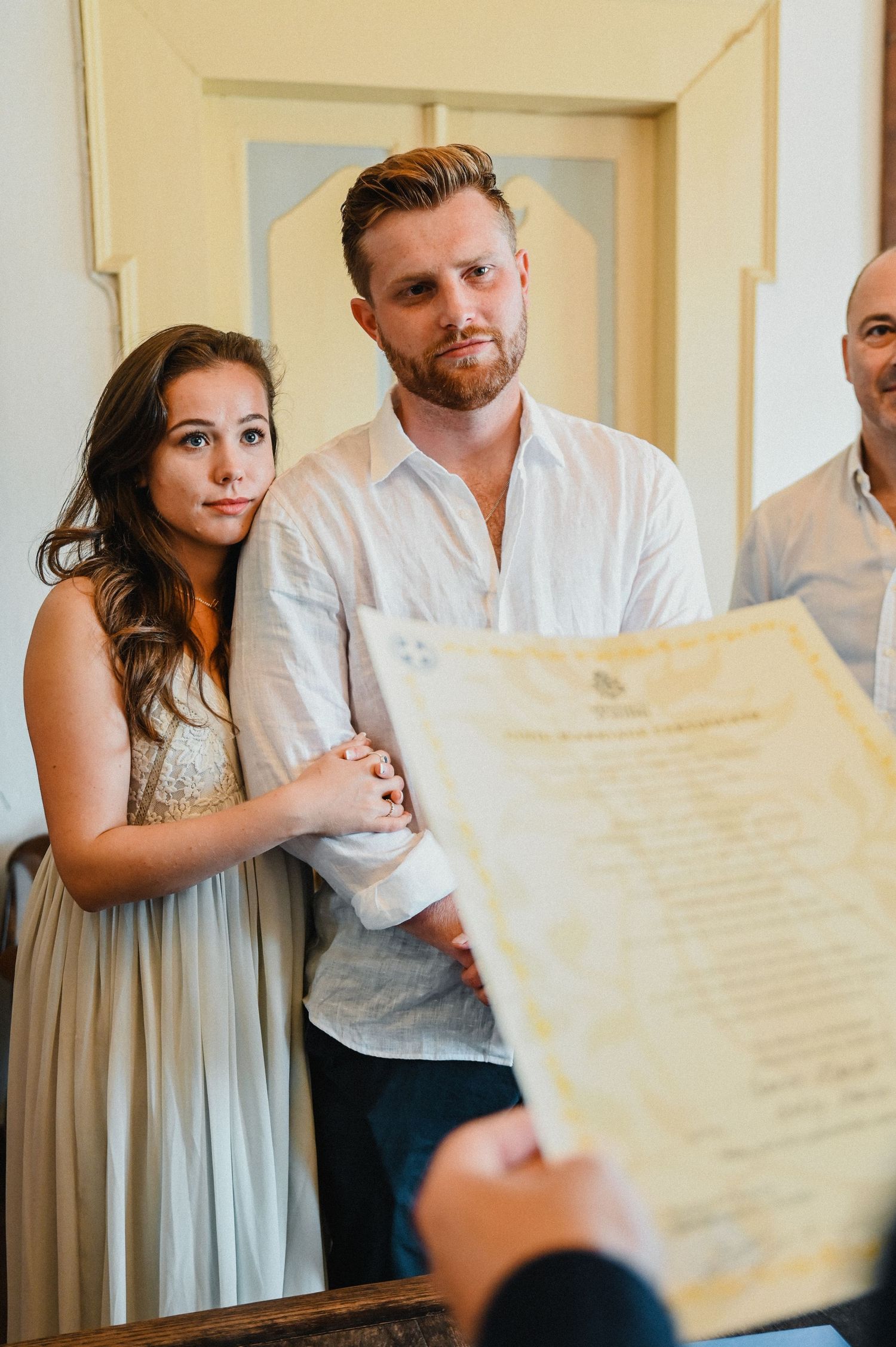 A couple reviews official documents during a ceremony.