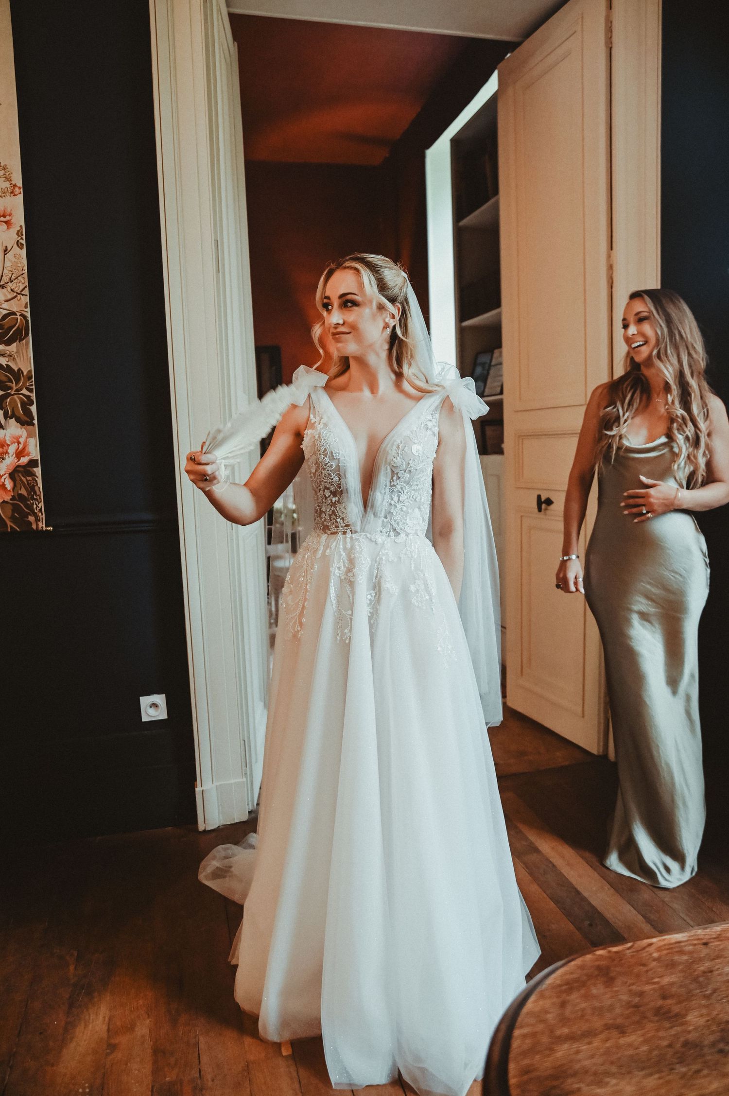 An elegant wedding preparation scene in a vintage room with hardwood floors and natural light.