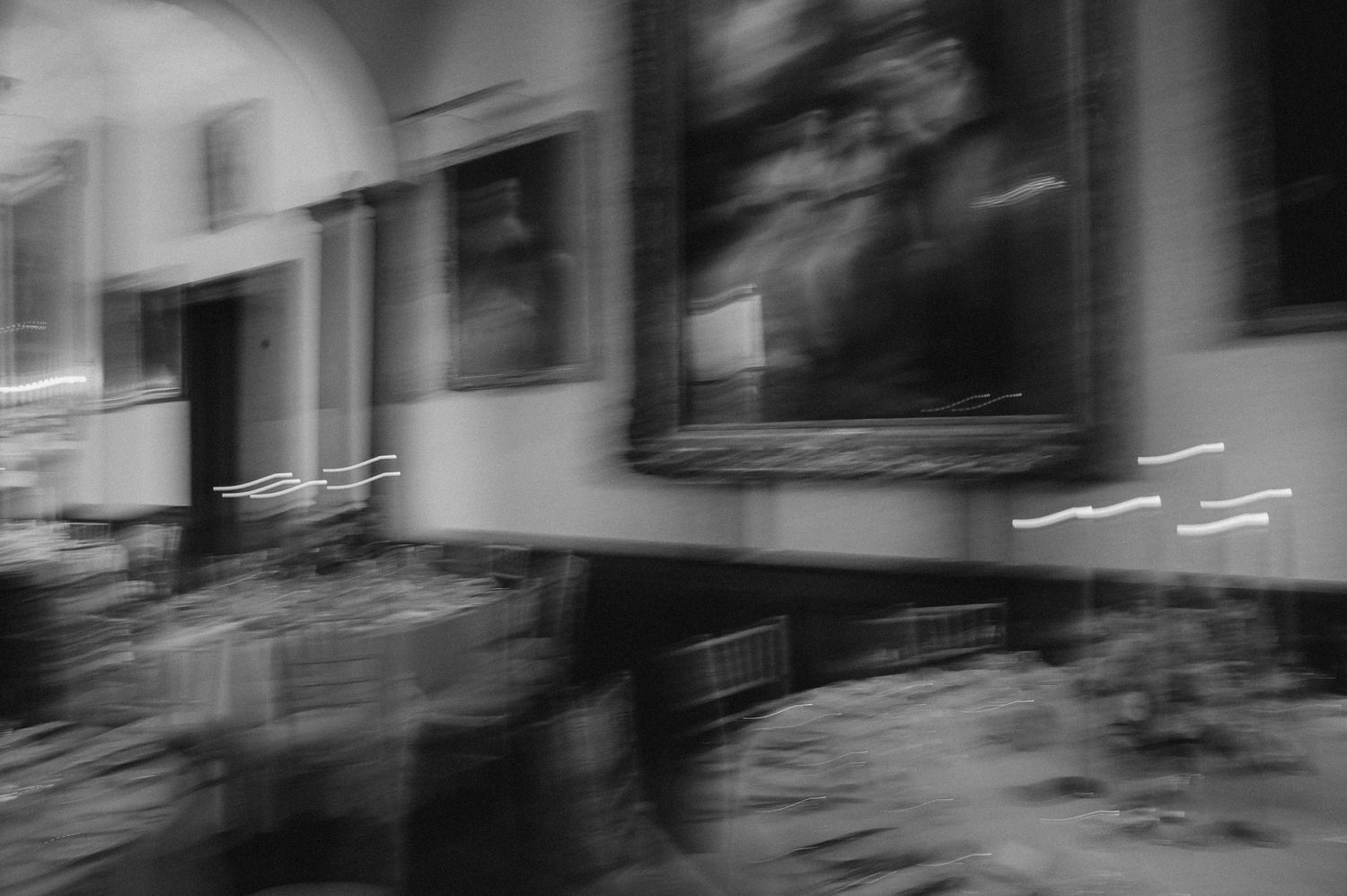 Abstract black and white motion blur photograph of building exterior with dramatic lighting effects.