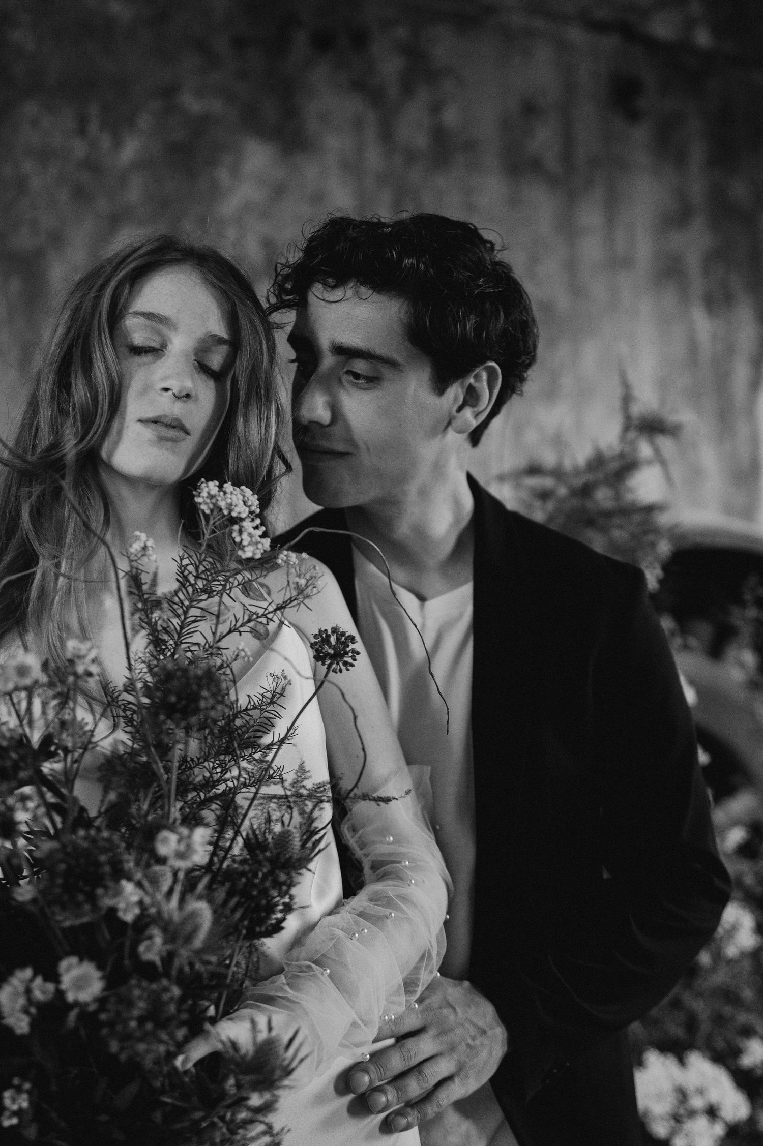 An intimate black and white portrait with vintage-inspired wedding details and natural florals.