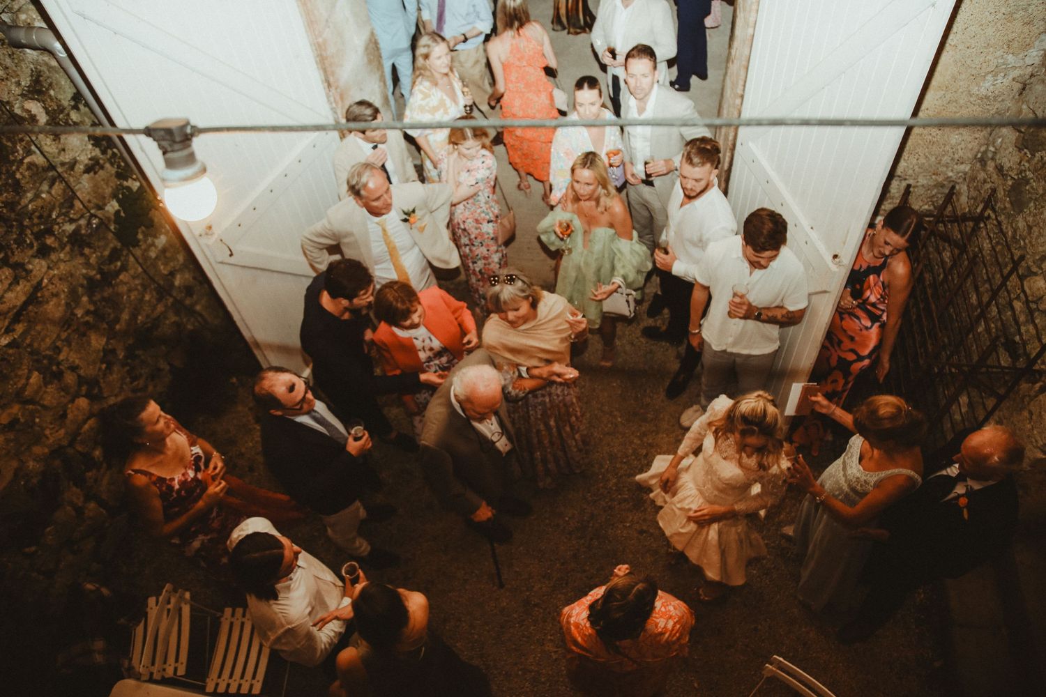 Aerial view of wedding guests dancing and celebrating on a dance floor.