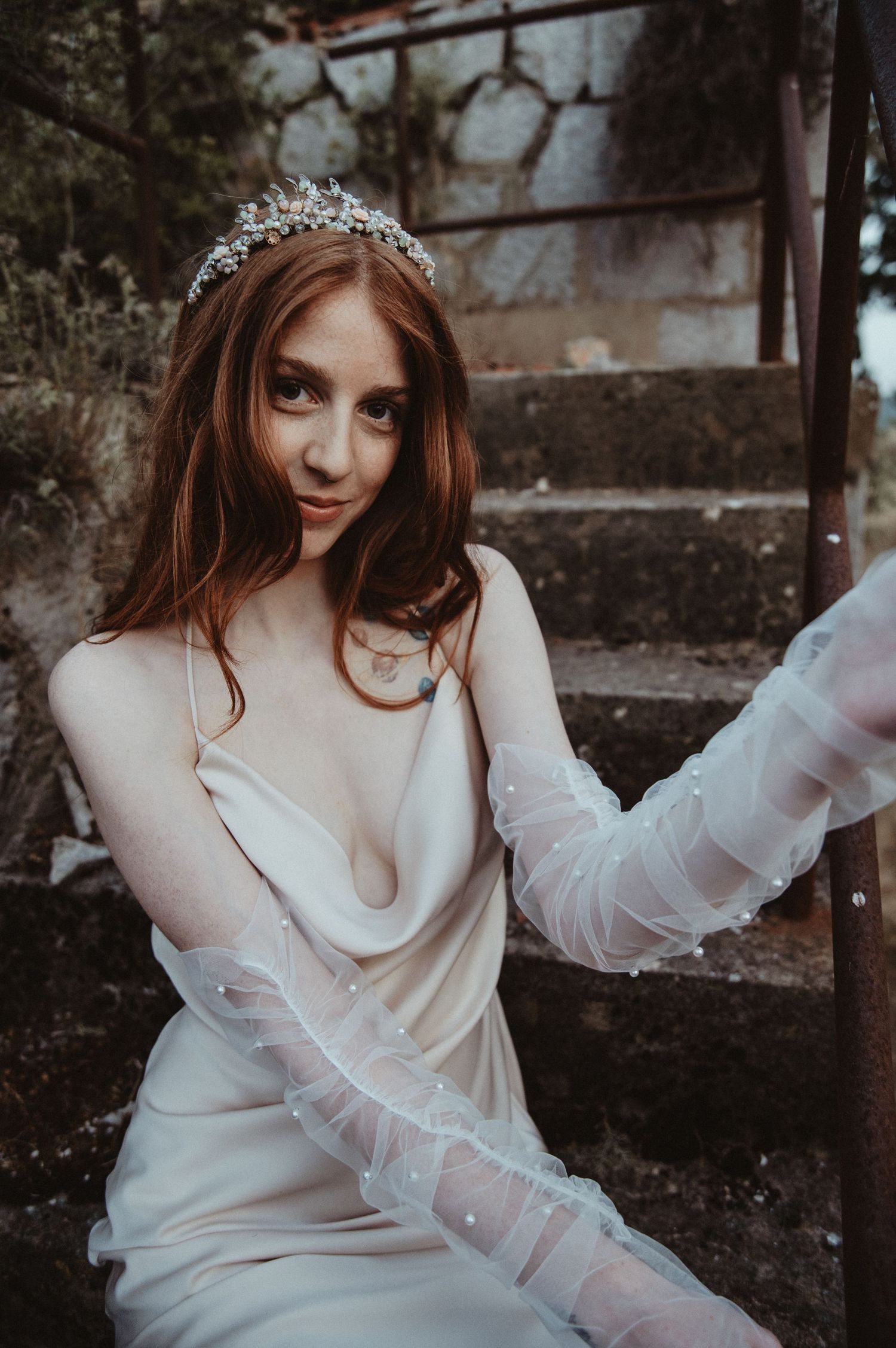 Romantic bridal portrait with crystal crown and sheer long gloves in muted tones.