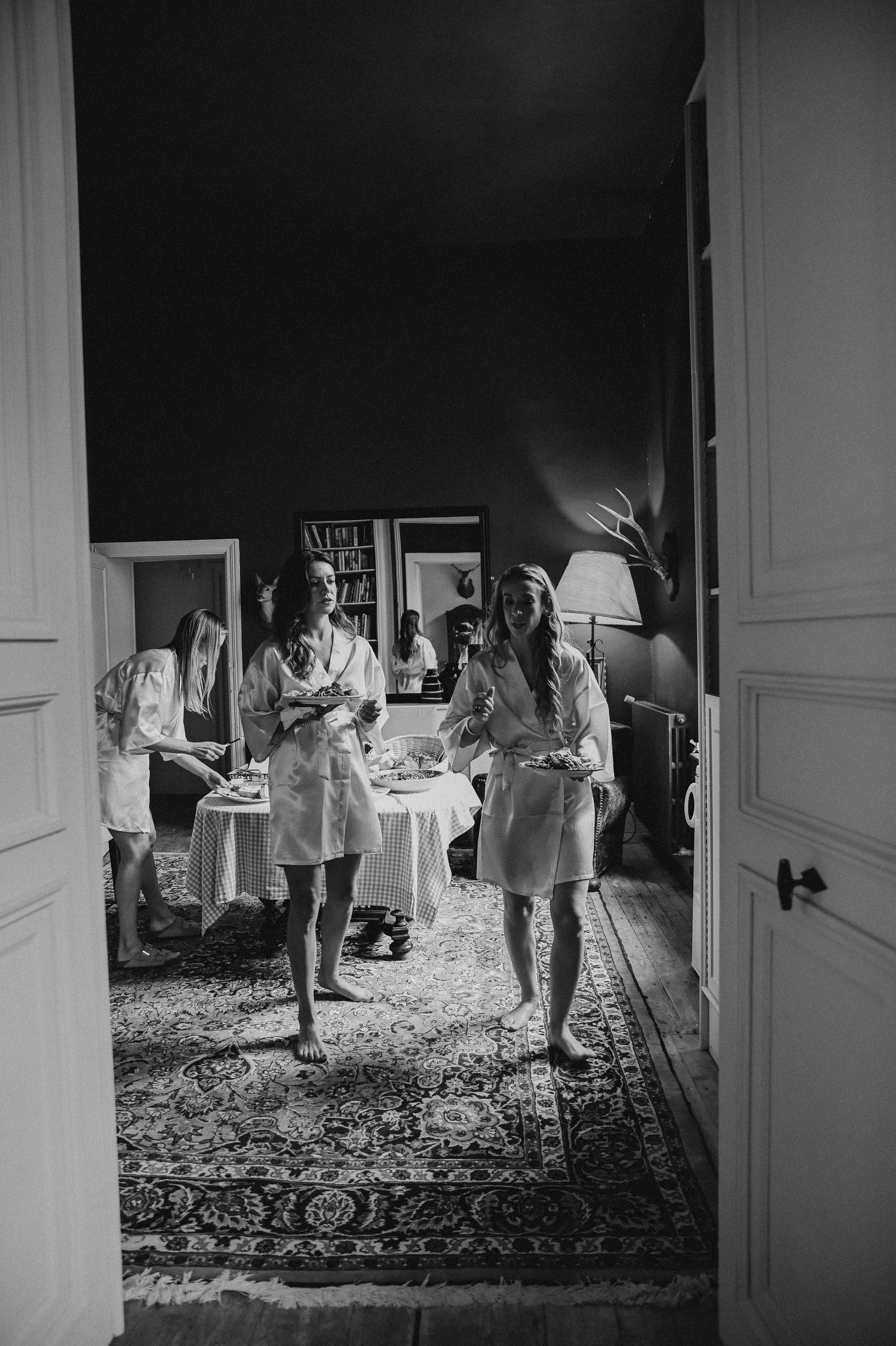 Black and white photograph of a casual indoor gathering.