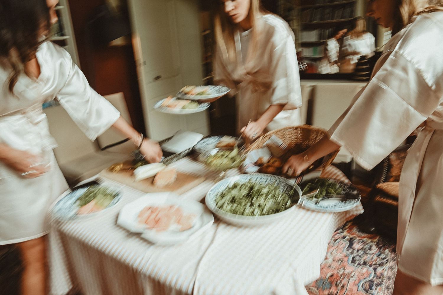 Blurred motion shot of people serving food at a casual gathering.