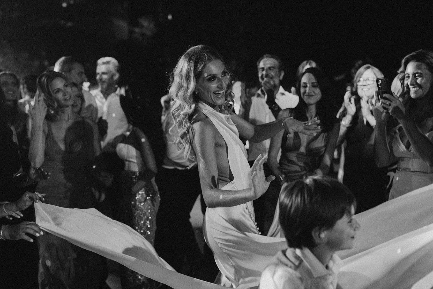 Wedding reception dance party with guests celebrating on dance floor.