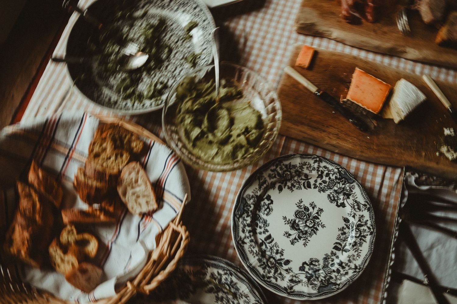 Overhead view of traditional plates with food and snacks on a wooden table.