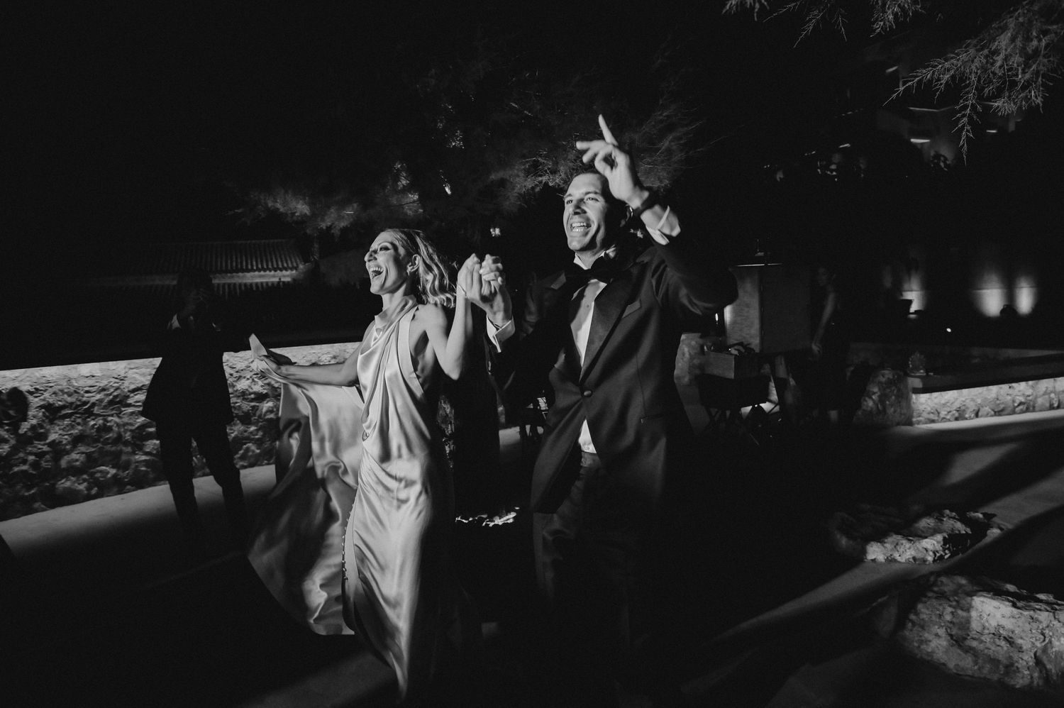 Dancing celebration at night with illuminated outdoor lighting.