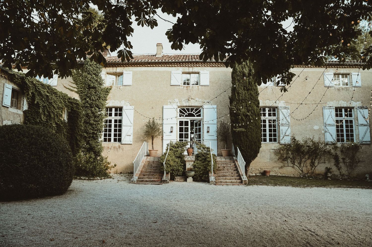 Classic French country house with symmetrical windows and elegant stone facade.