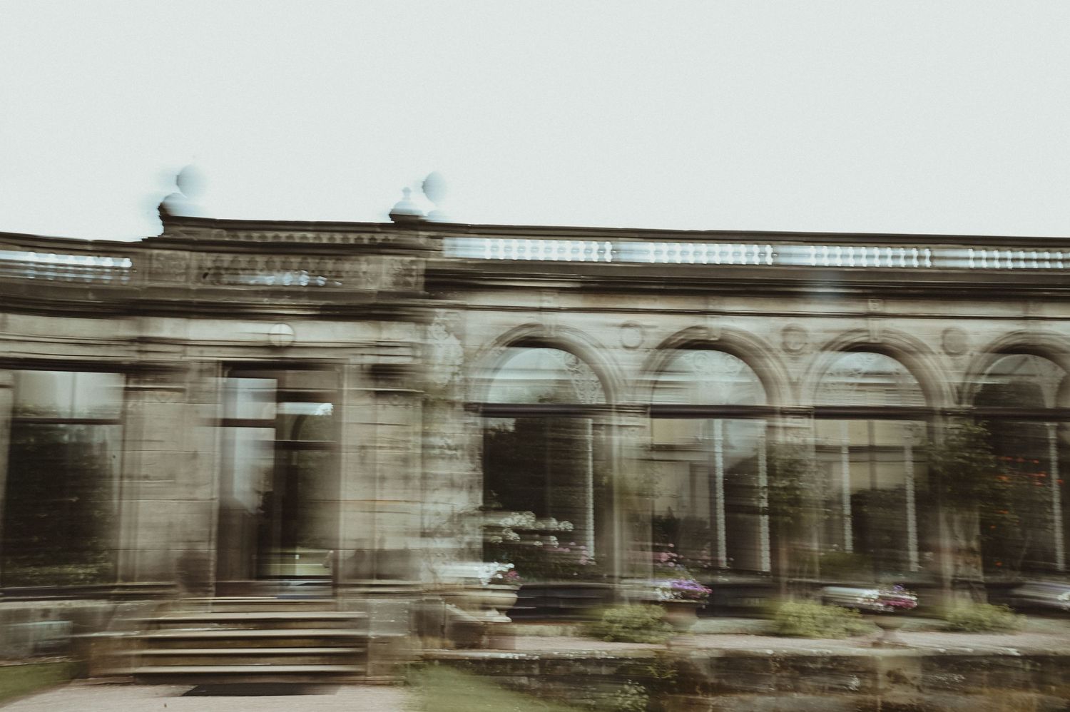 Ancient stone archways and columns create a moody architectural scene in black and white.