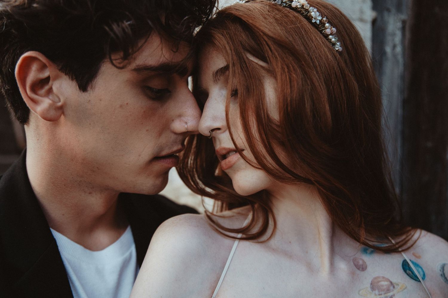 A tender moment between bride and groom captured in dreamy warm tones.
