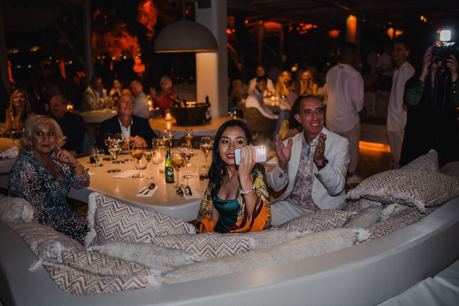 Wedding guests enjoying themselves in a cozy lounge area during the reception.