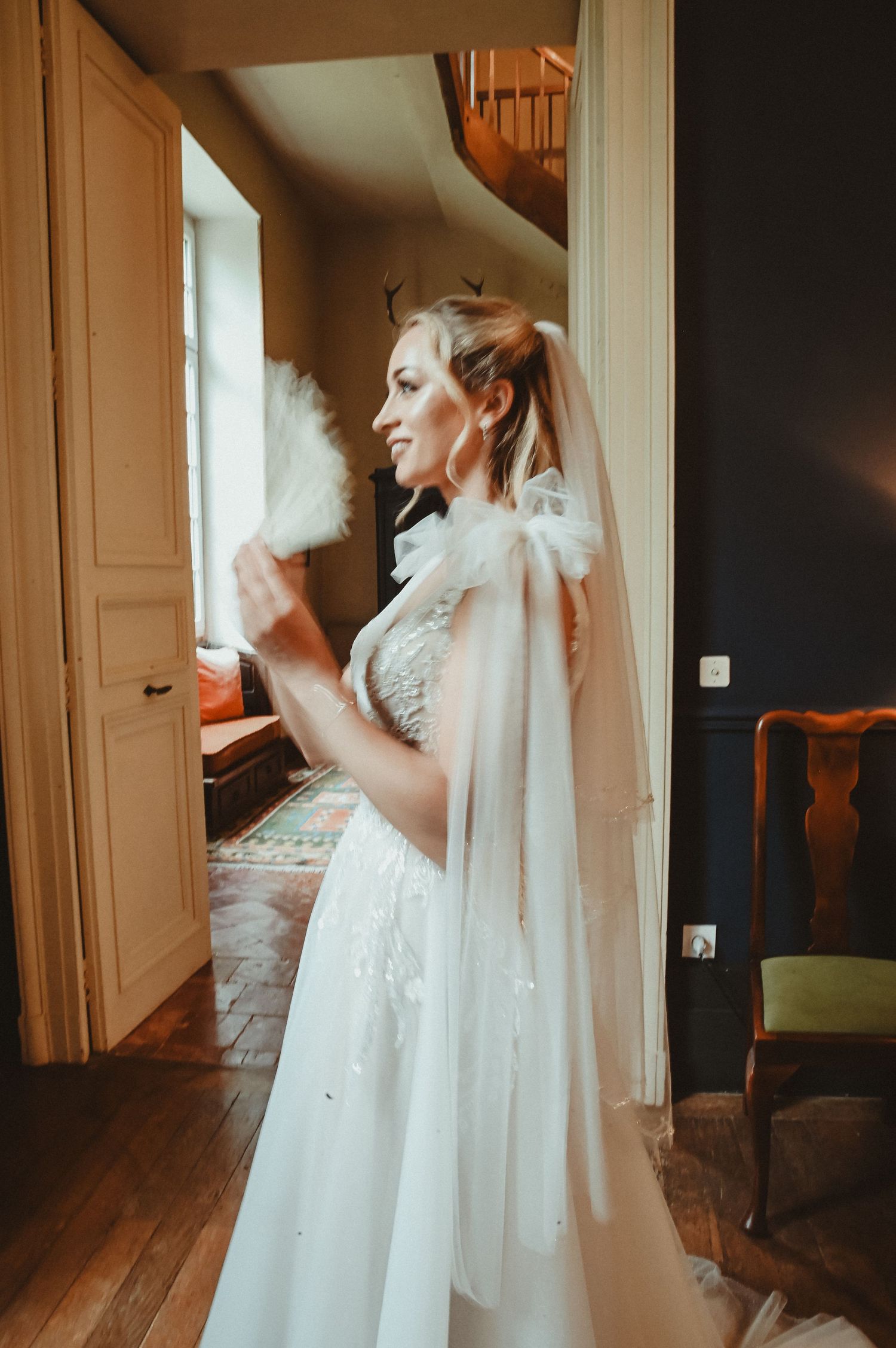 Atmospheric wedding portrait in warm lighting by a vintage doorway.
