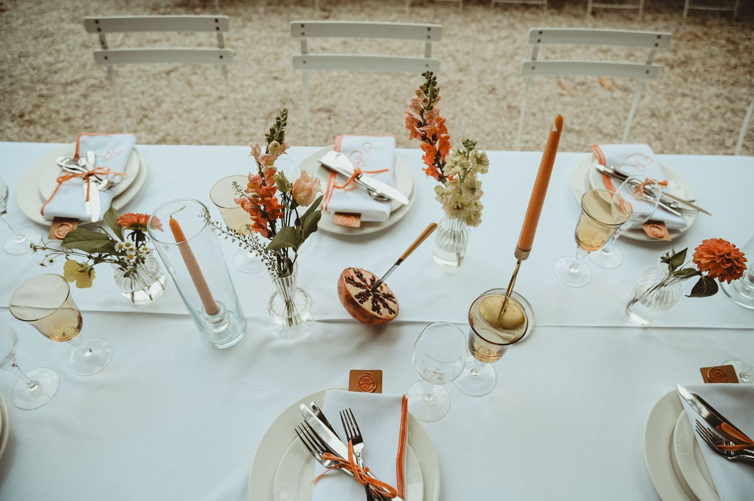 Close-up of wedding table decor featuring terracotta and floral arrangements.