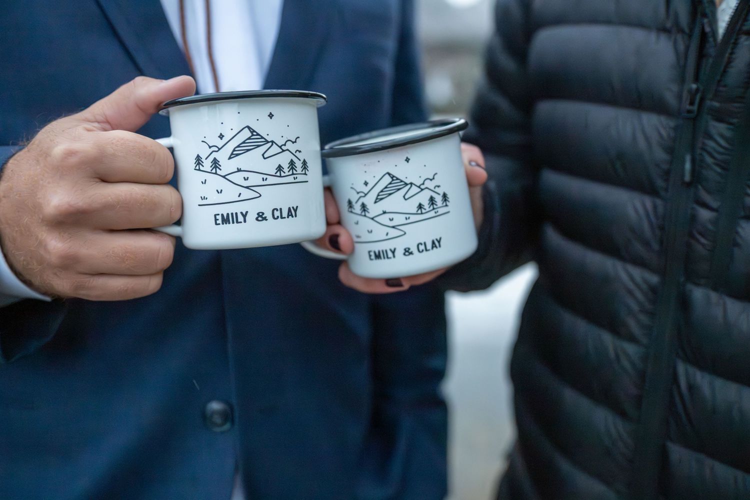 an eloping couple make a toast with their coffee for their sunrise Colorado elopement. The mugs are customized with their names on them.