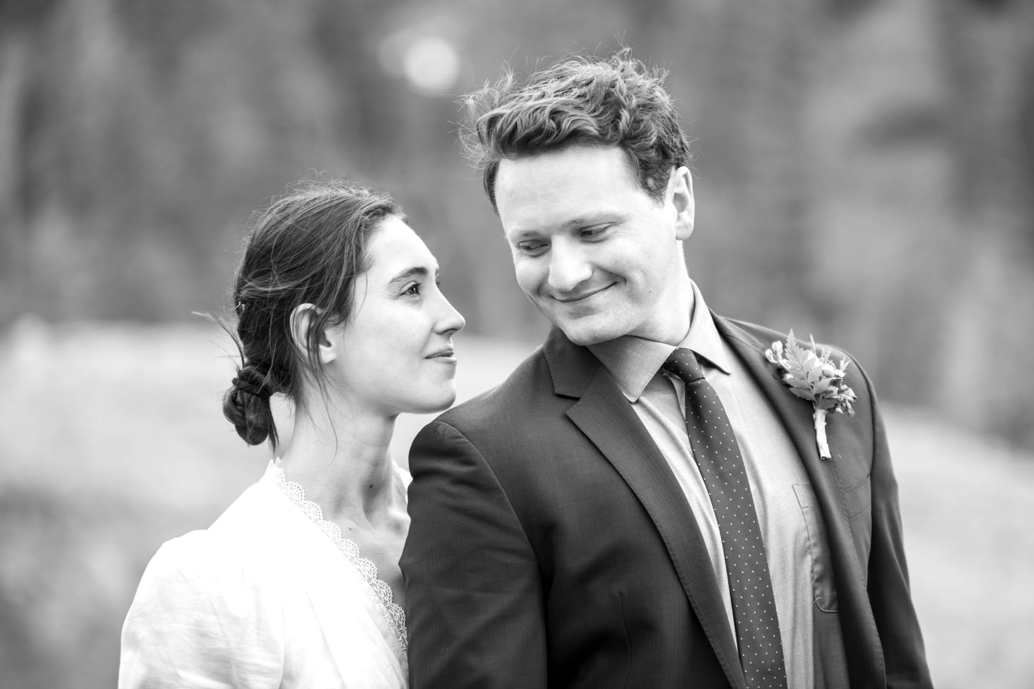 A black and white wedding portrait of a smiling bride and groom looking at each other during their elopement near Ouray.
