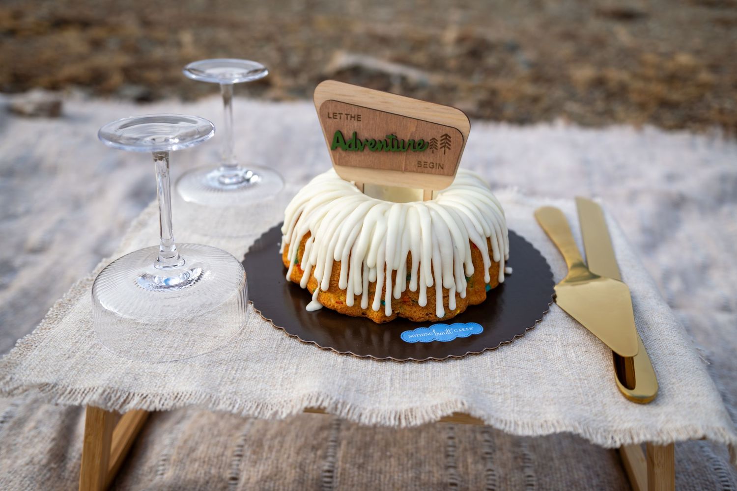 A Bundt cake serves as a wedding cake with a sign that says 