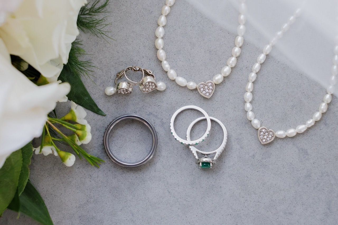 Wedding bands. the engagement ring, bride's accessories  presented in a flat lay during a wedding in Snohomish by Tim Neal Photography