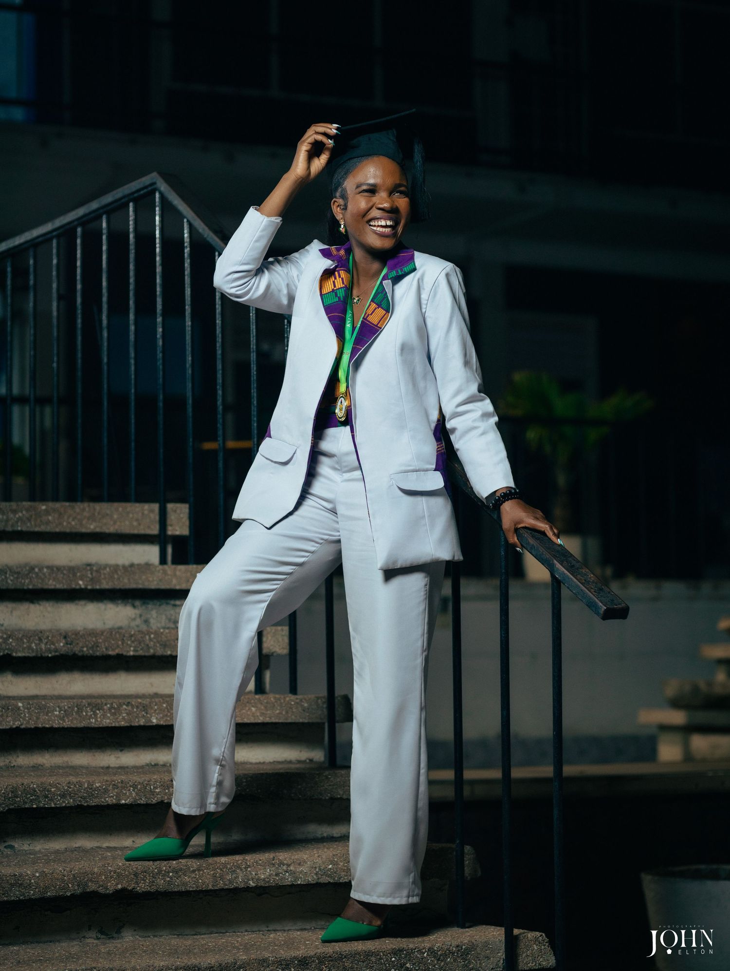 Person in white pantsuit strikes dynamic poses on outdoor steps with elegant style.