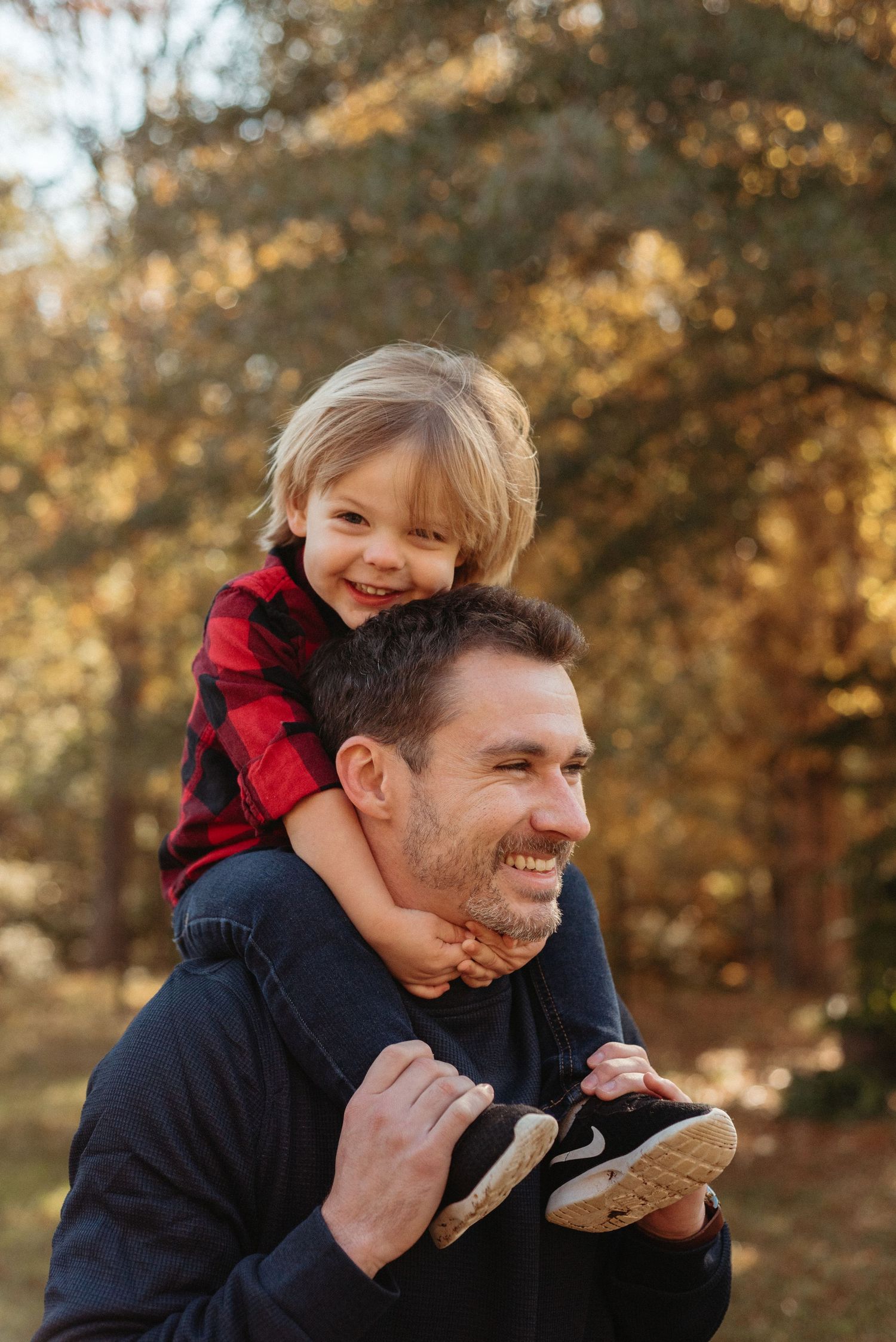 Playful moments captured between parent and child in an autumn forest setting.