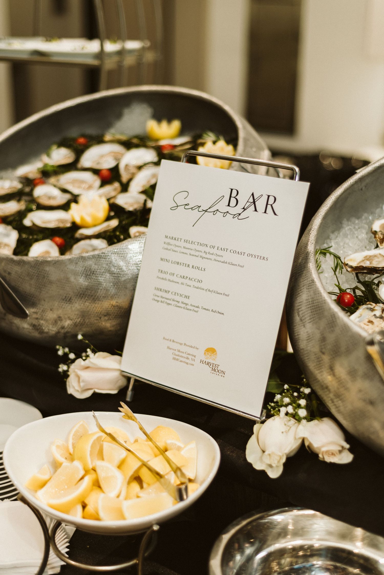 Seafood bar display with menu cards and appetizers on dark plates.