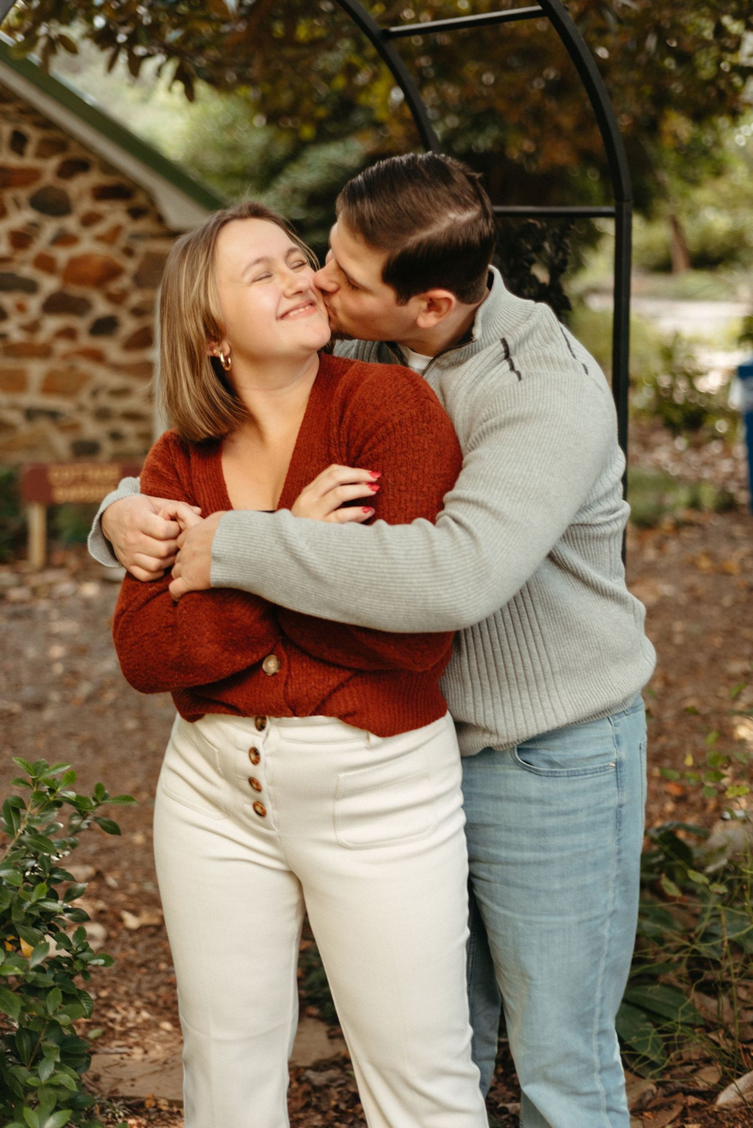 Playful romantic sequence showing couple in autumn sweaters embracing outdoors.