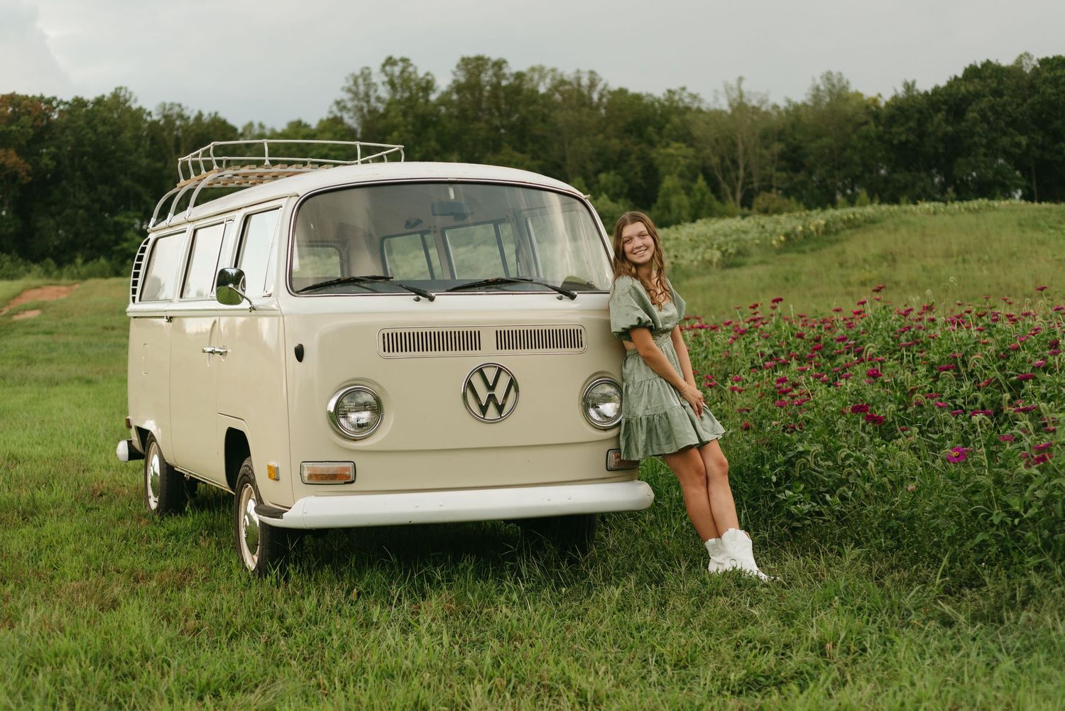A classic cream Volkswagen bus stretches across multiple frames in a grassy field.