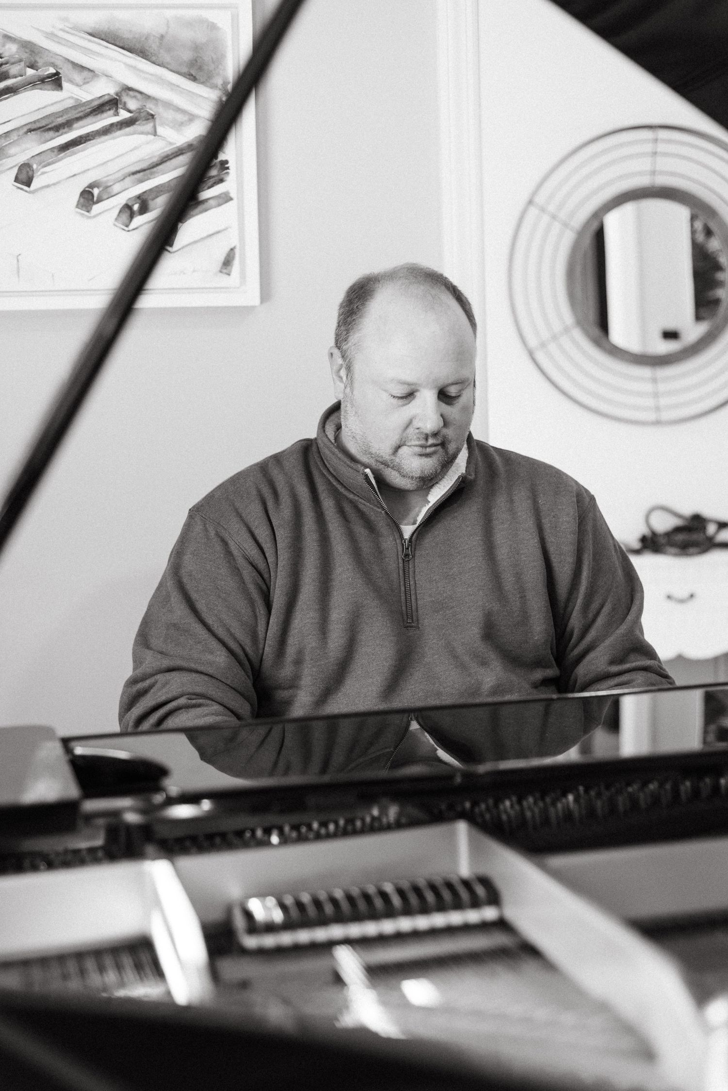 Black and white photos of pianist performing at grand piano.