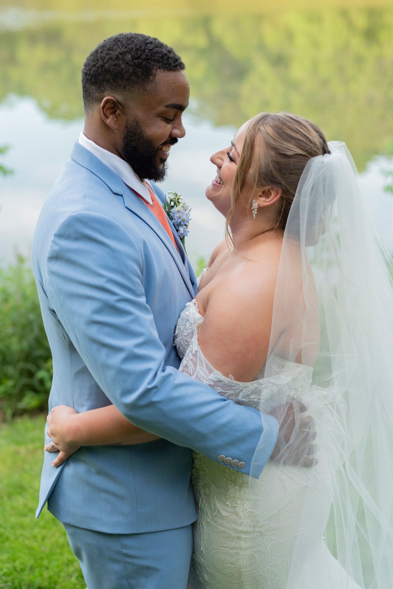 Intimate wedding portraits showing a couple embracing outdoors in a garden setting.