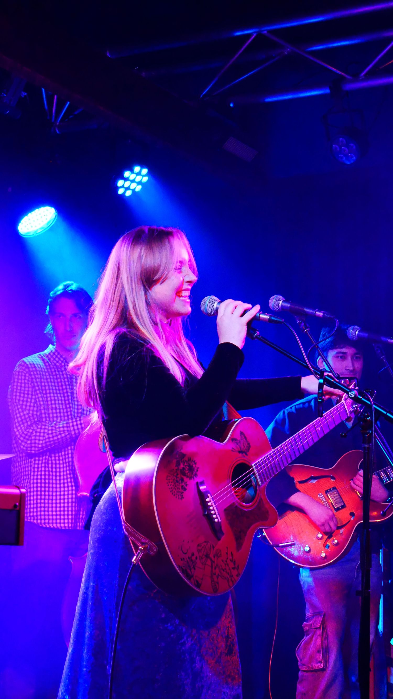 Chelsea Elder holding guitar at gig