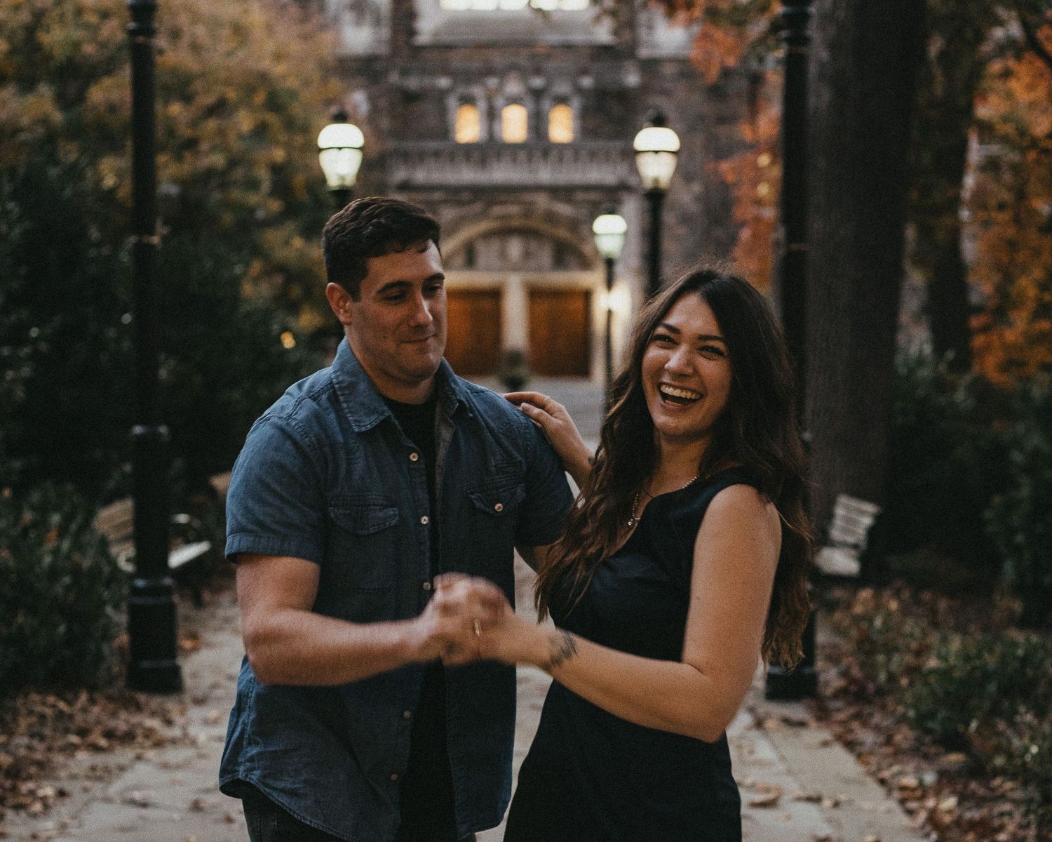 Candid photo of an engaged couple dancing and laughing during a fall sunset session in Bethlehem.