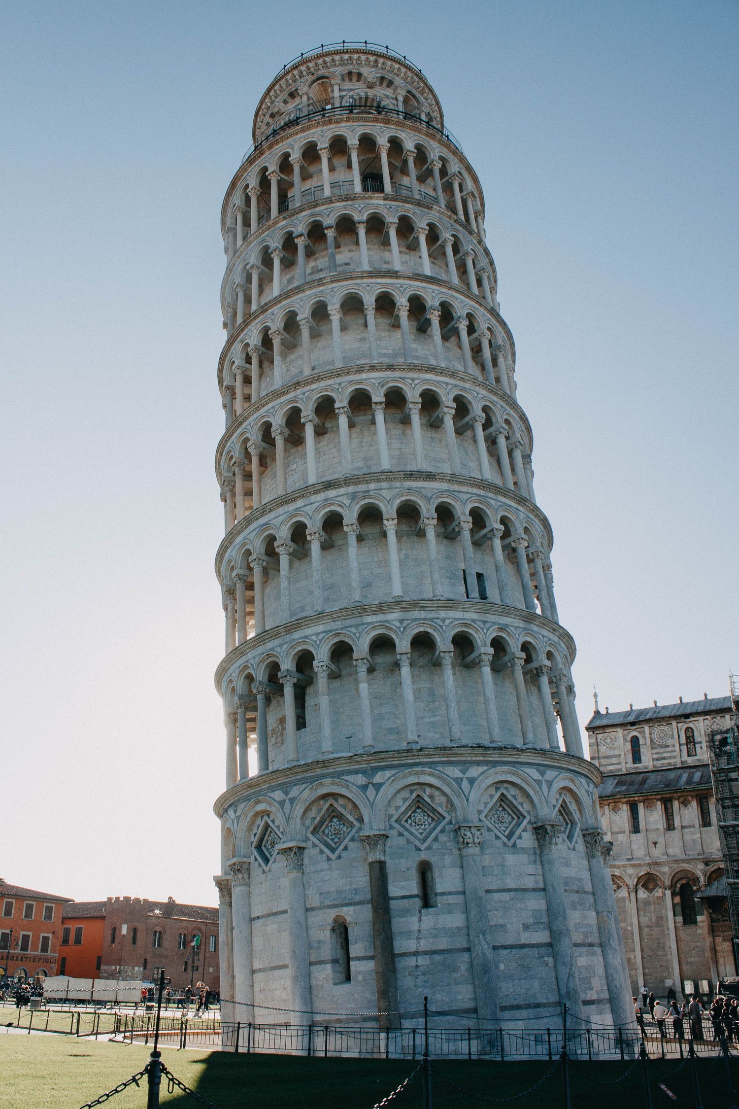 The famous Leaning Tower of Pisa rising against a clear blue sky in Pisa, Italy.