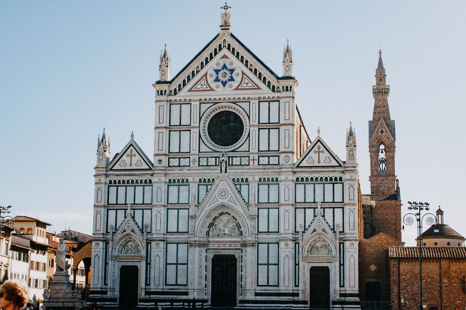 The stunning white marble Gothic facade of the Basilica di Santa Croce in Florence, Italy.