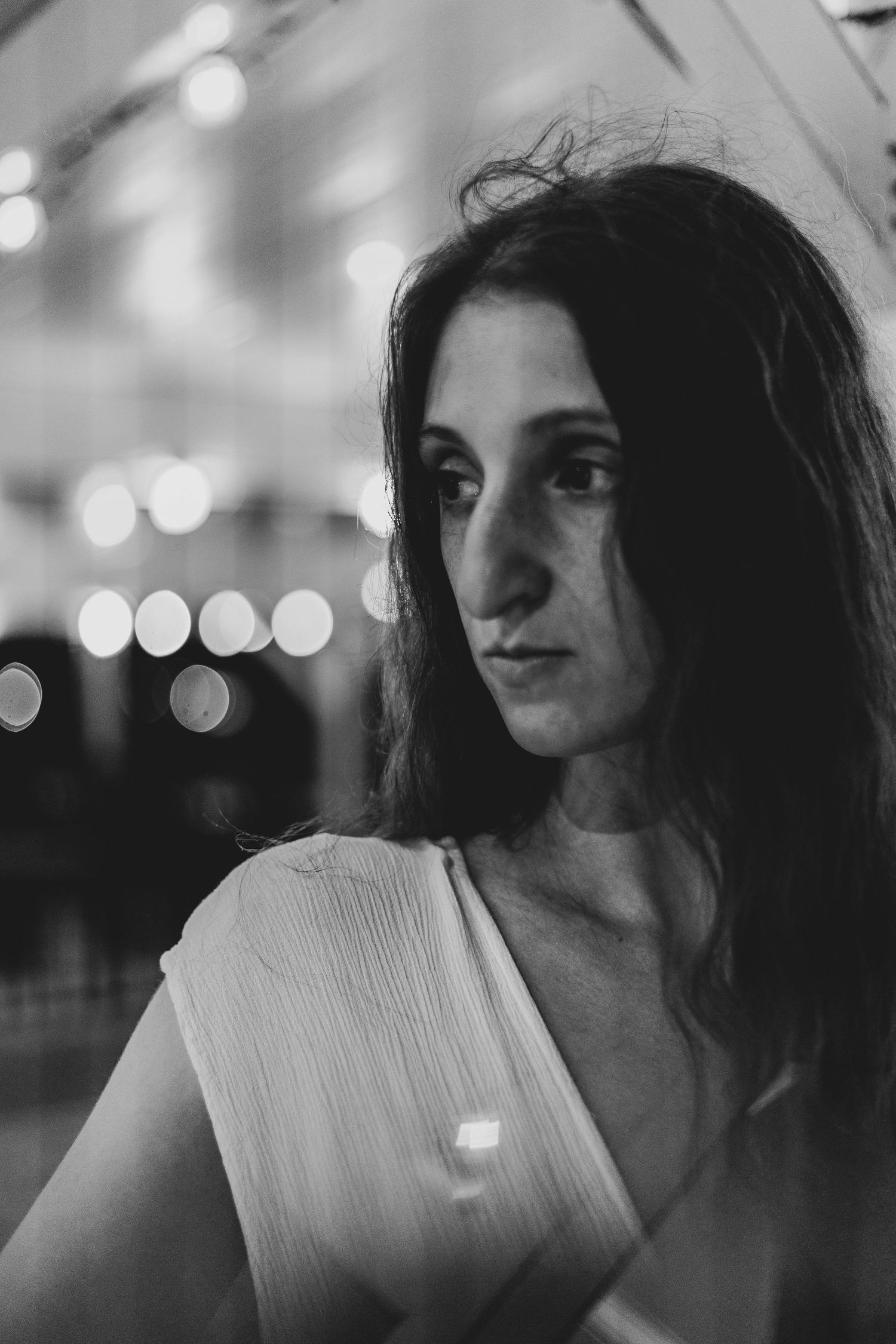 Intimate black and white portrait of a woman with long hair looking down, showcasing the dramatic lighting style of a Scranton wedding photo