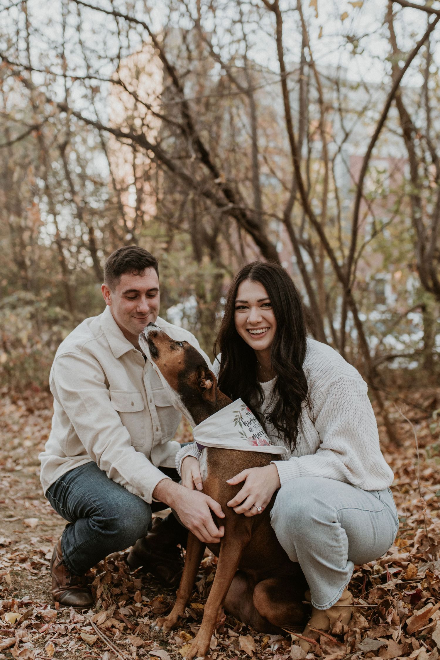 A couple posing with their dog during an autumn engagement session in Bethlehem, featuring a 