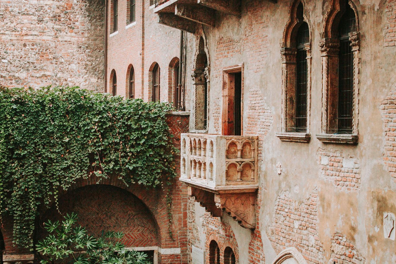 Juliet's famous balcony covered in ivy at Casa di Giulietta in Verona, Italy.
