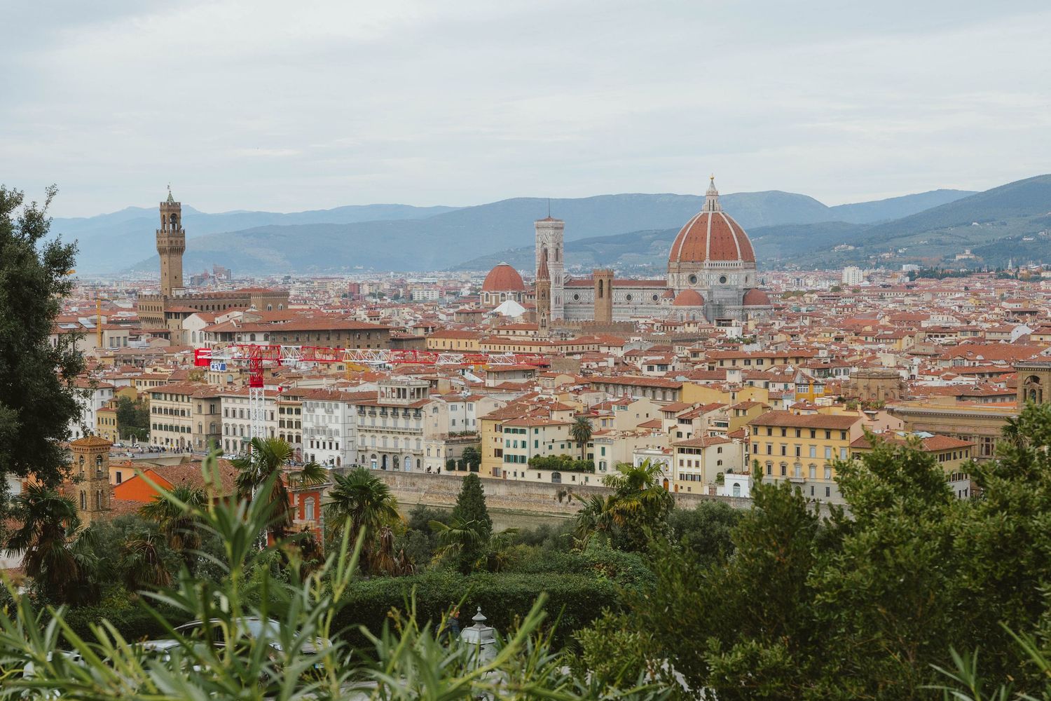 Panoramic view of Florence skyline with the iconic Duomo cathedral dome and Palazzo Vecchio.