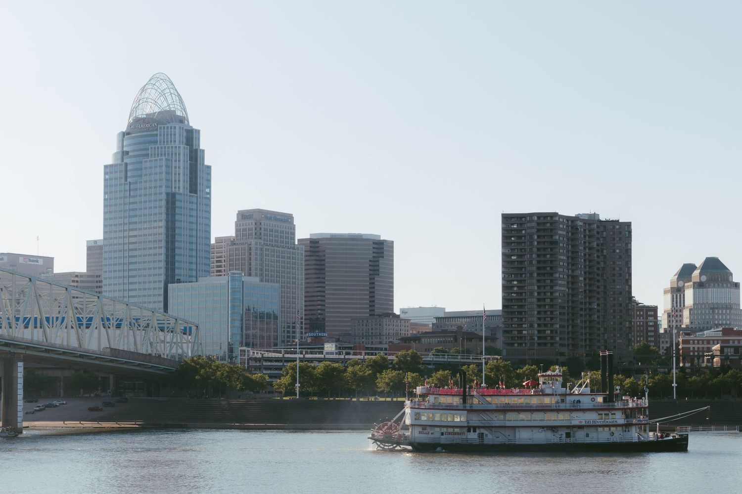 Cincinnati city skyline with the iconic Great American Tower reflected over the Ohio River.