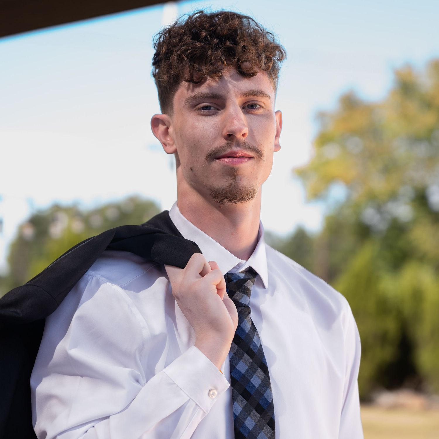 Young professional in white dress shirt in natural lighting. Alpharetta headshots real estate agent