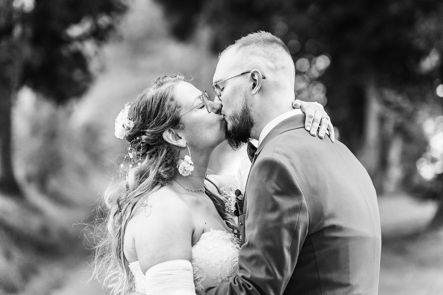Intimate black and white romantic moments captured in natural outdoor settings.